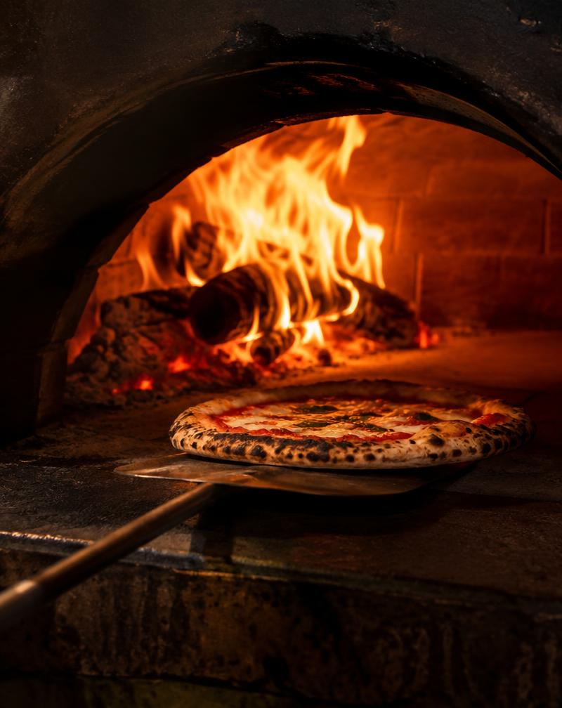 Pizza baking in a wood-fired oven